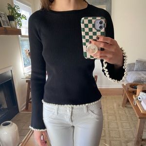 Black sweater with white trim